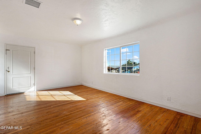 spare room featuring hardwood / wood-style floors