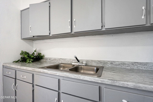 kitchen featuring gray cabinets and sink