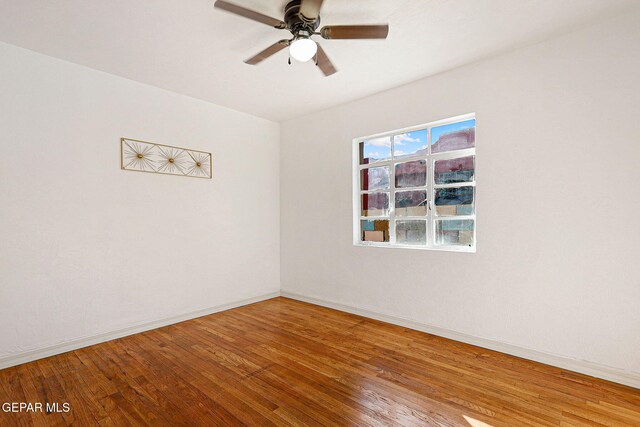 empty room with wood-type flooring and ceiling fan