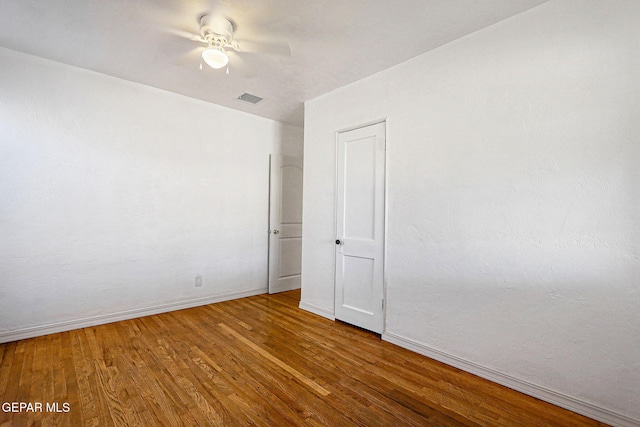 spare room featuring hardwood / wood-style flooring and ceiling fan