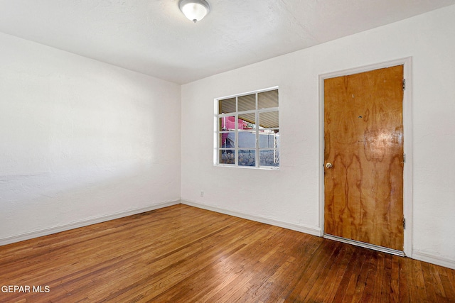 unfurnished room featuring hardwood / wood-style flooring