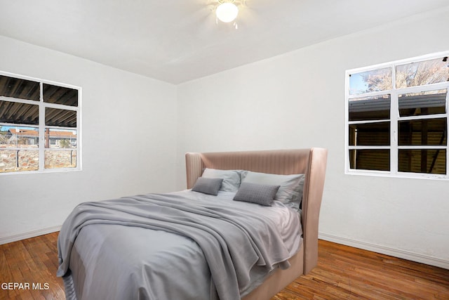 bedroom with wood-type flooring and ceiling fan