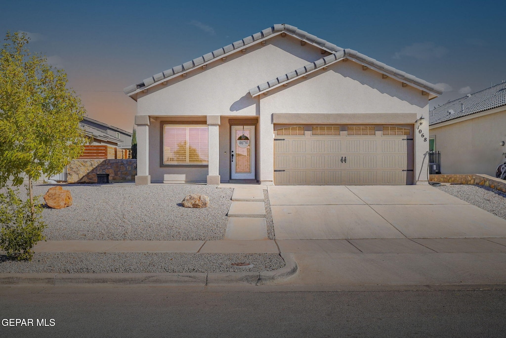 view of front of home with a porch and a garage