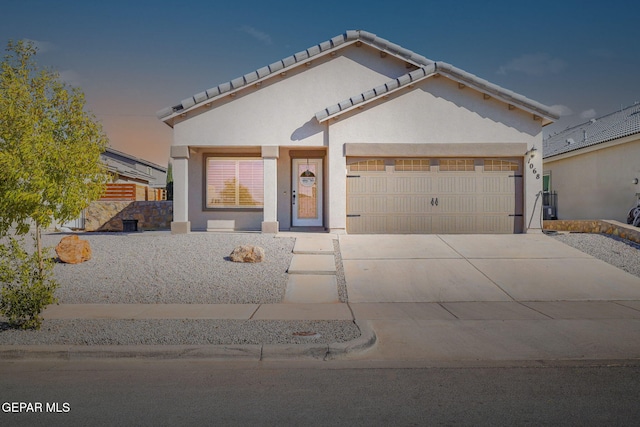 view of front of home with a porch and a garage