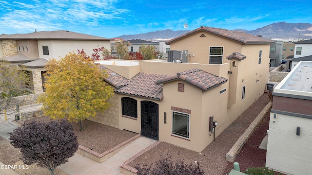 view of front of house featuring a mountain view and a patio area