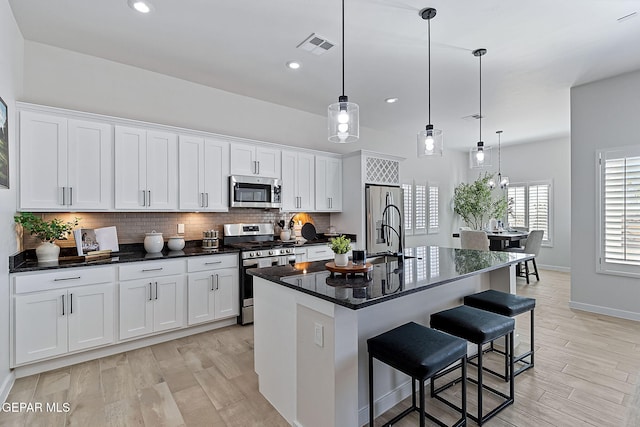 15224 Gauge Ct, El Paso, TX 79938 - kitchen with appliances with stainless steel finishes, white cabinets, an island with sink, a sink, and recessed lighting