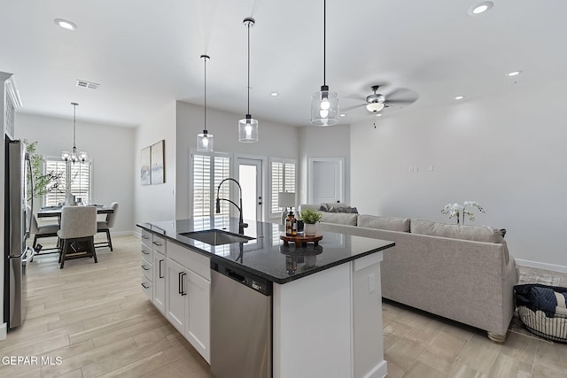 15224 Gauge Ct, El Paso, TX 79938 - kitchen featuring appliances with stainless steel finishes, a sink, open floor plan, ceiling fan, and white cabinetry