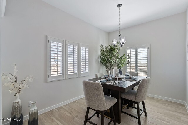 15224 Gauge Ct, El Paso, TX 79938 - dining area featuring a chandelier, light wood-style floors, and baseboards