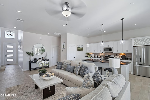 15224 Gauge Ct, El Paso, TX 79938 - living area with light wood-style floors, ceiling fan, recessed lighting, a chandelier, and baseboards