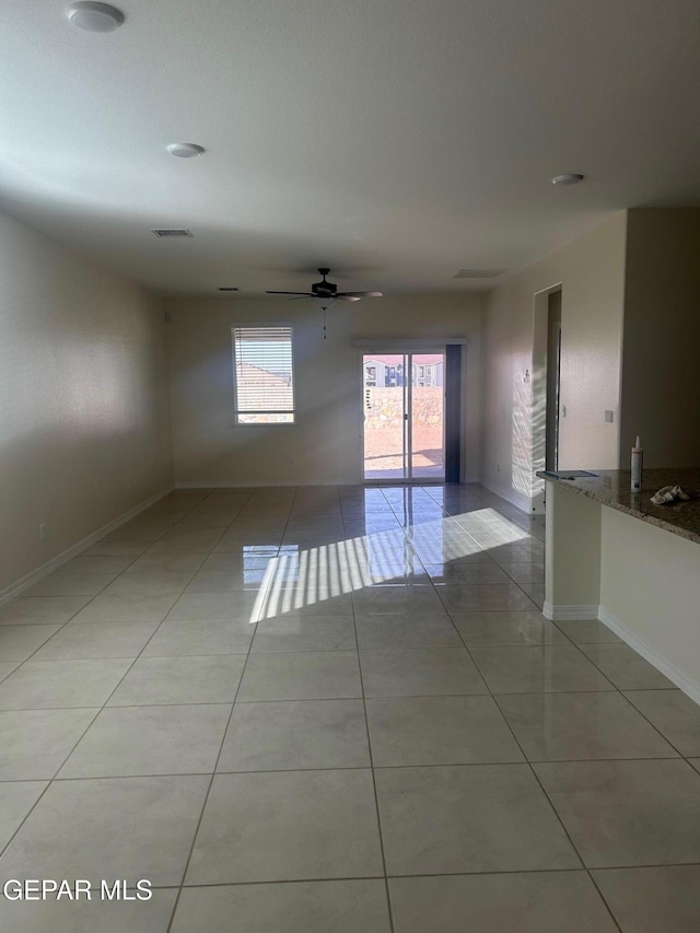 tiled empty room with ceiling fan