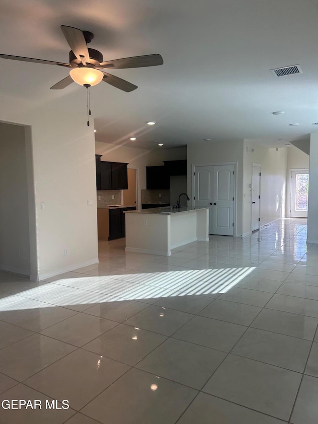 interior space with ceiling fan