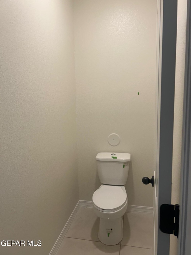 bathroom with toilet and tile patterned flooring