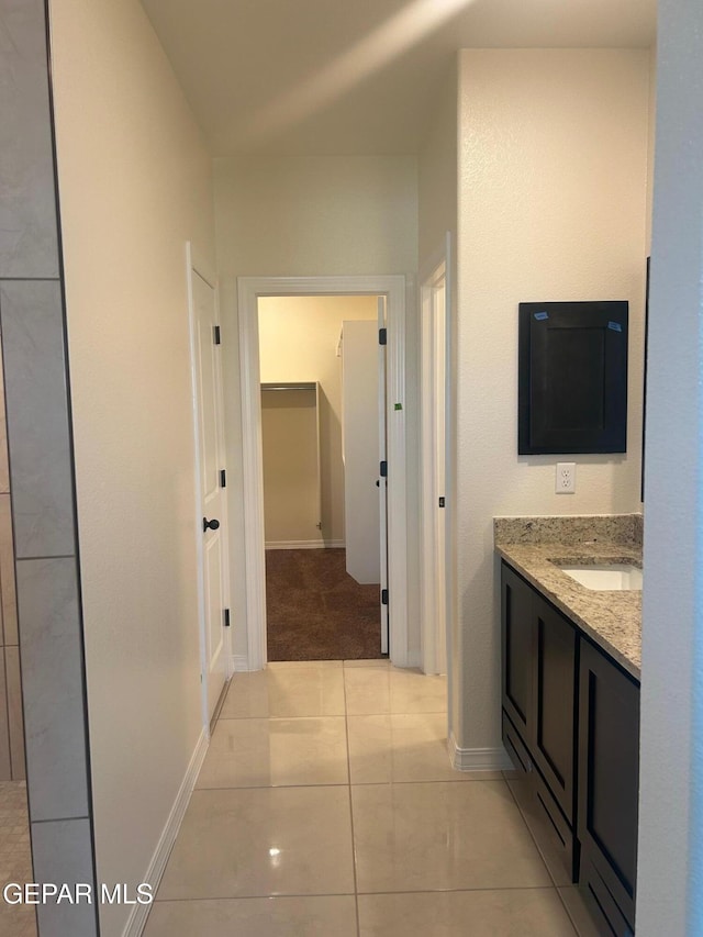 hall with sink and light tile patterned floors