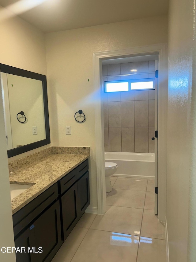 full bathroom featuring toilet, vanity, tiled shower / bath combo, and tile patterned flooring