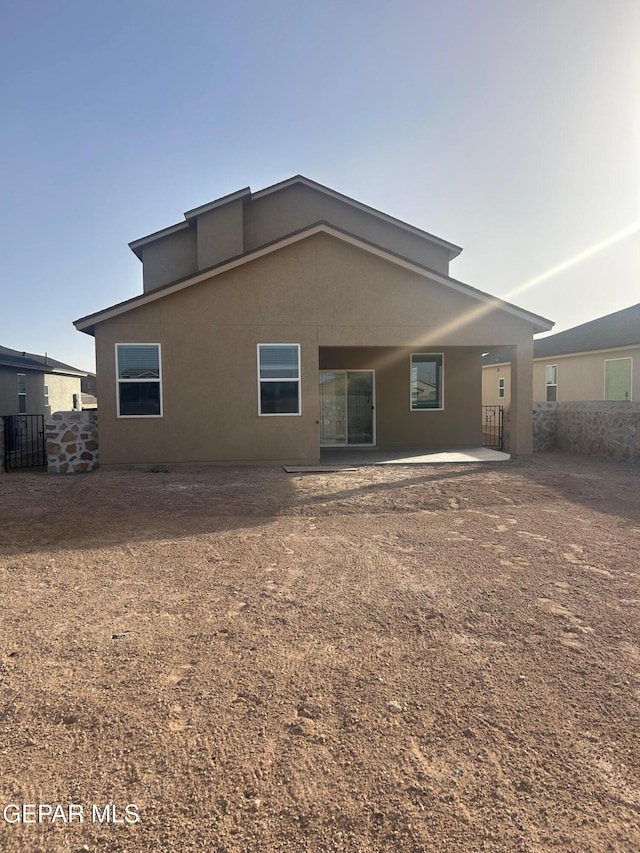 back of property with a patio