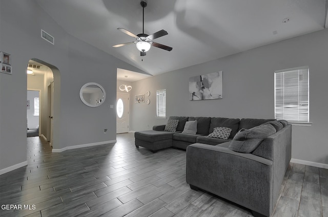 living room featuring a healthy amount of sunlight, ceiling fan, lofted ceiling, and wood-type flooring