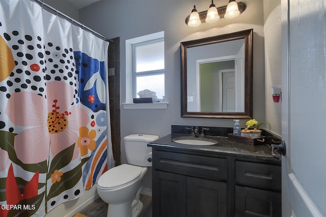 bathroom with wood-type flooring, vanity, toilet, and walk in shower