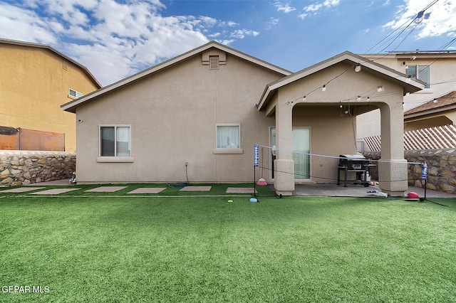 rear view of house featuring a lawn