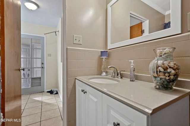 bathroom featuring tile patterned flooring, vanity, and crown molding