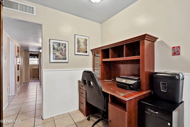 office area with light tile patterned floors and wood walls