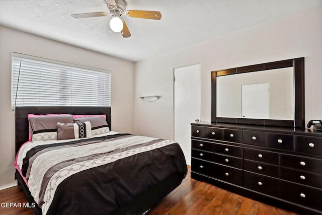 bedroom with ceiling fan and dark wood-type flooring