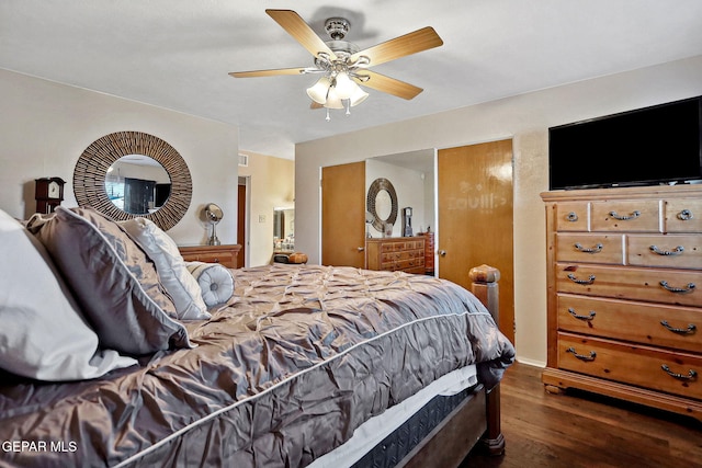 bedroom with ceiling fan and dark wood-type flooring