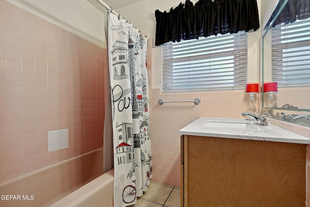 bathroom featuring tile patterned floors, a wealth of natural light, and tile walls