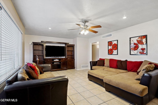 tiled living room with ceiling fan