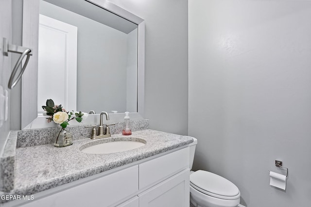 bathroom featuring vanity and toilet