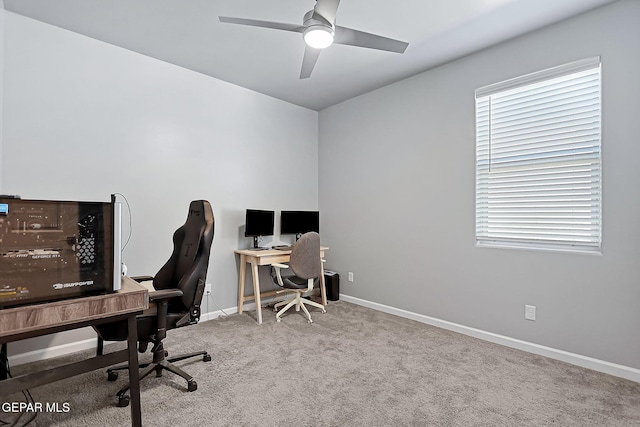 office space featuring light carpet and ceiling fan