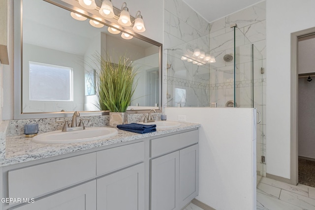 bathroom featuring vanity and a shower with door