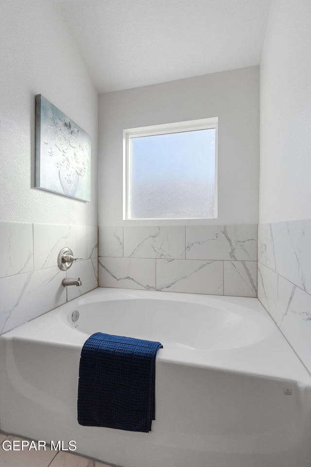 bathroom featuring a tub to relax in