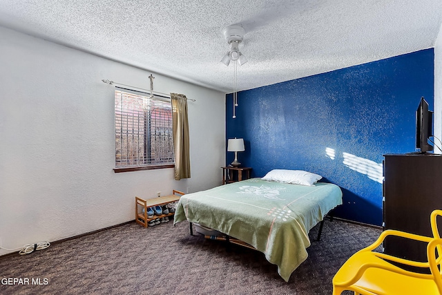 carpeted bedroom with a textured ceiling and ceiling fan