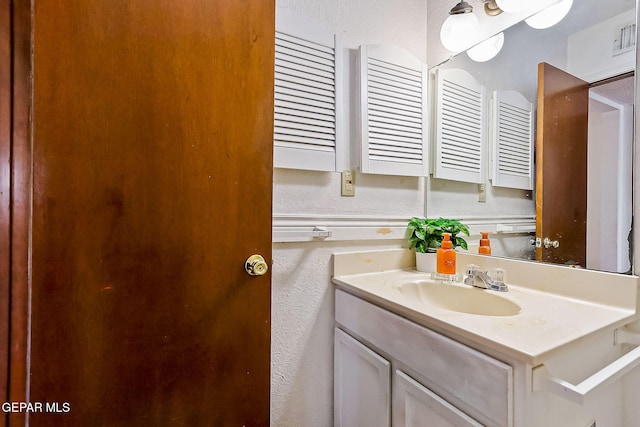 bathroom with radiator heating unit and vanity