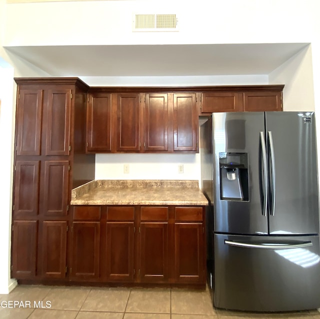 kitchen with stainless steel fridge and light tile patterned floors