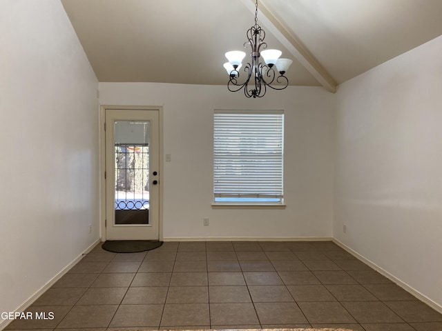 interior space with a chandelier, dark tile patterned floors, and lofted ceiling with beams