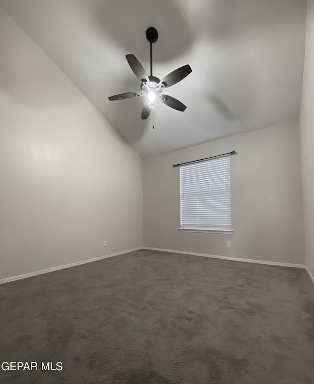 carpeted empty room with ceiling fan and vaulted ceiling