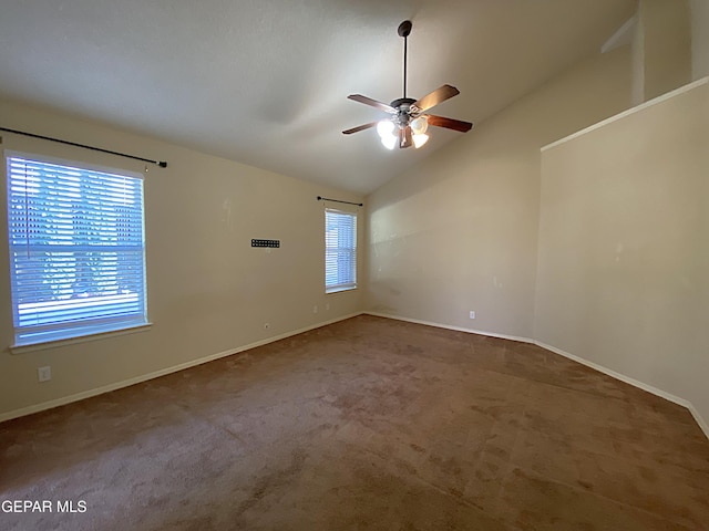 empty room featuring lofted ceiling, ceiling fan, and carpet floors