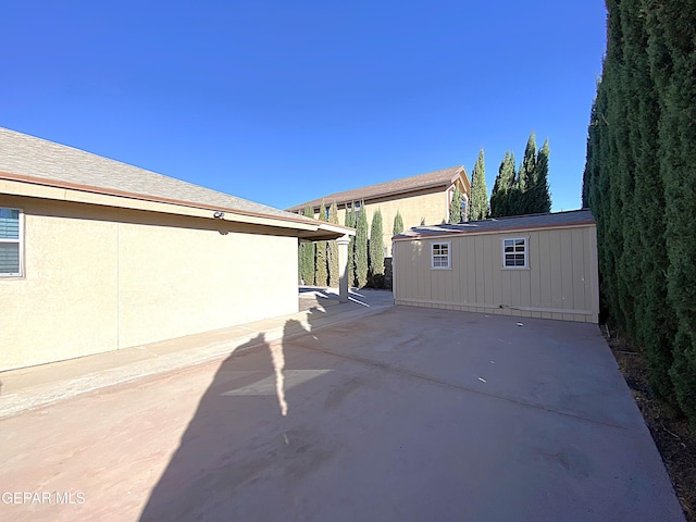 view of patio featuring an outbuilding