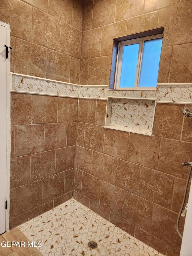 bathroom with a tile shower