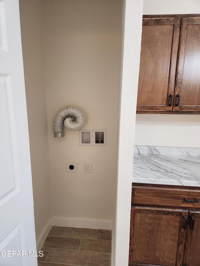 laundry area featuring electric dryer hookup, dark hardwood / wood-style floors, cabinets, and hookup for a washing machine