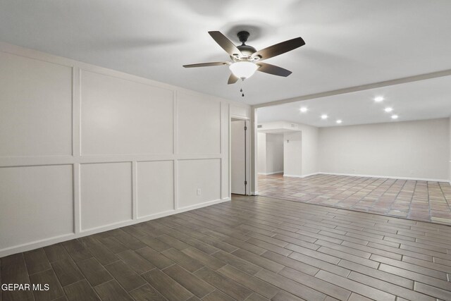 basement with dark hardwood / wood-style floors and ceiling fan