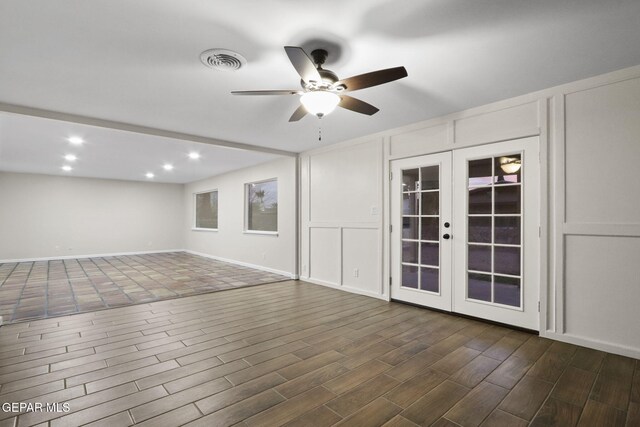 spare room featuring ceiling fan, dark hardwood / wood-style flooring, and french doors