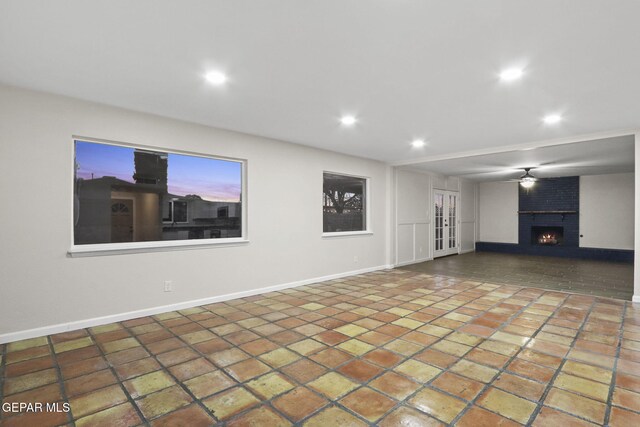 unfurnished living room featuring a brick fireplace