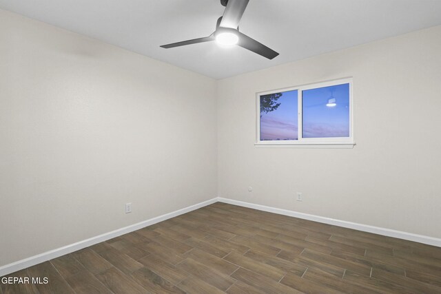 unfurnished room with ceiling fan and dark hardwood / wood-style floors