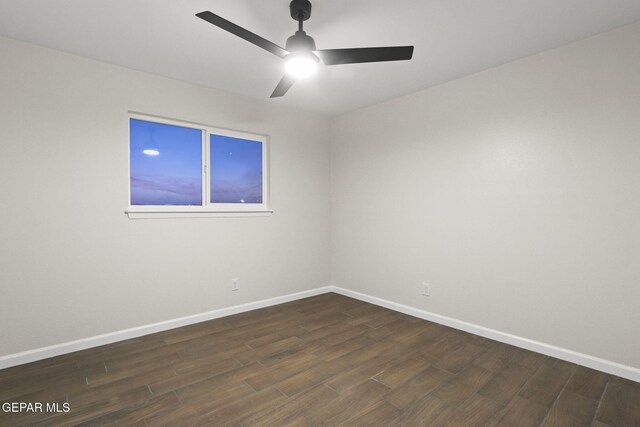 empty room with ceiling fan and dark hardwood / wood-style flooring