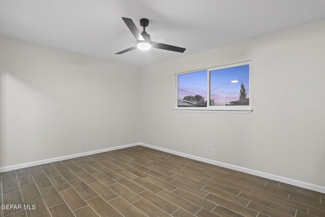 spare room with ceiling fan and dark hardwood / wood-style floors