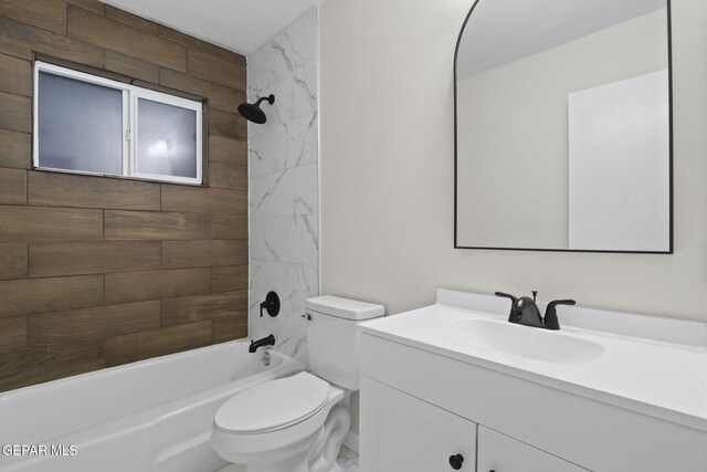 full bathroom featuring tiled shower / bath combo, toilet, and vanity