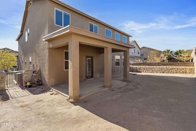 back of house with a patio and central AC