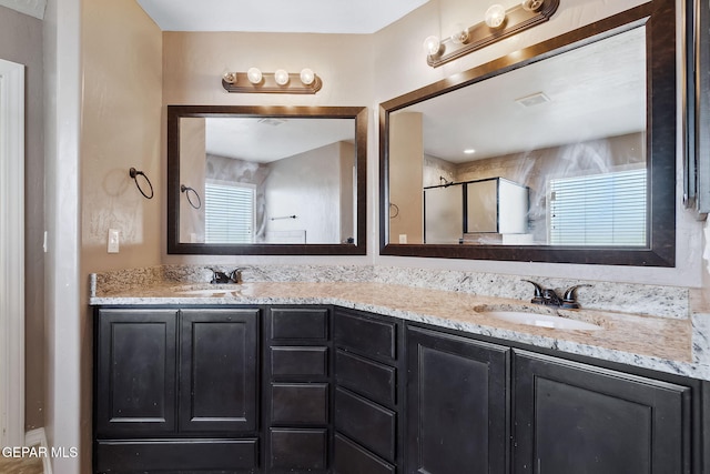 bathroom featuring vanity and a shower with shower door